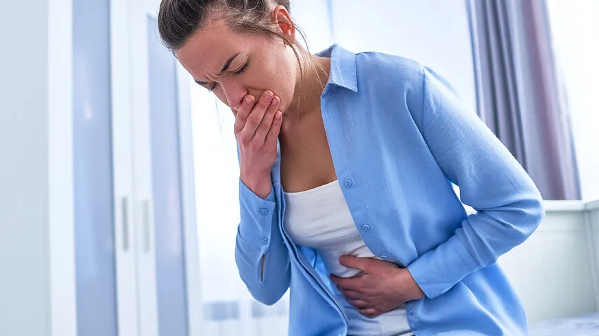 Woman holding her stomach and mouth with indigestion