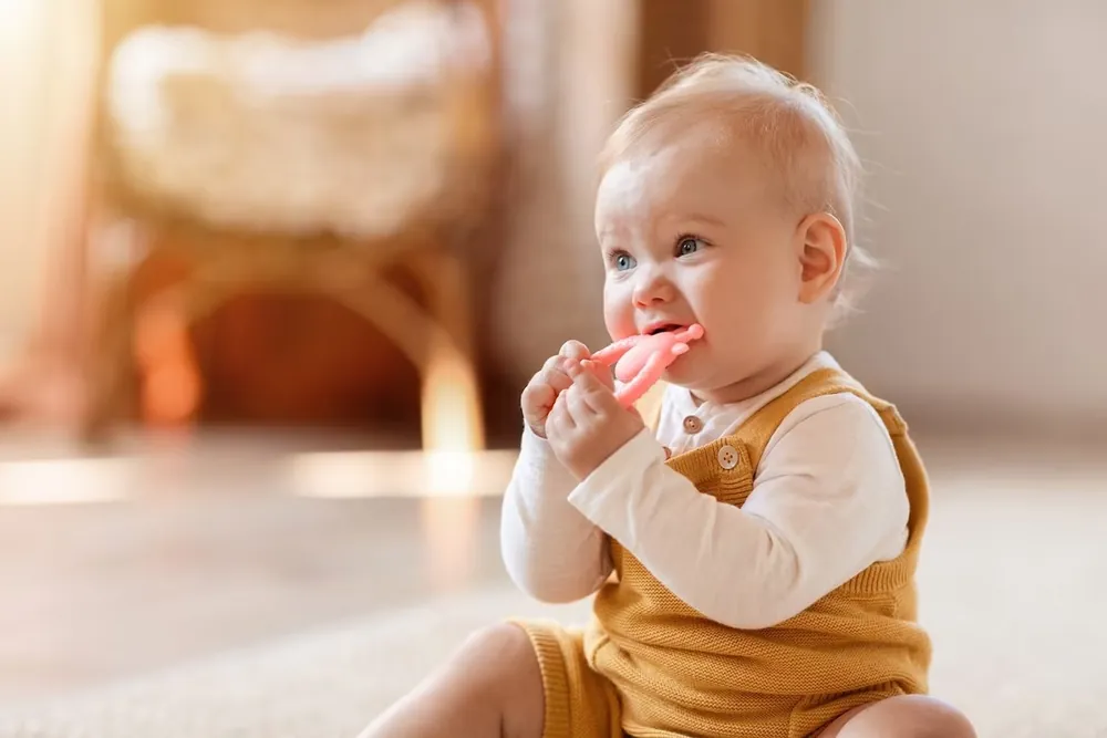 Baby chewing on a silicone teething toy