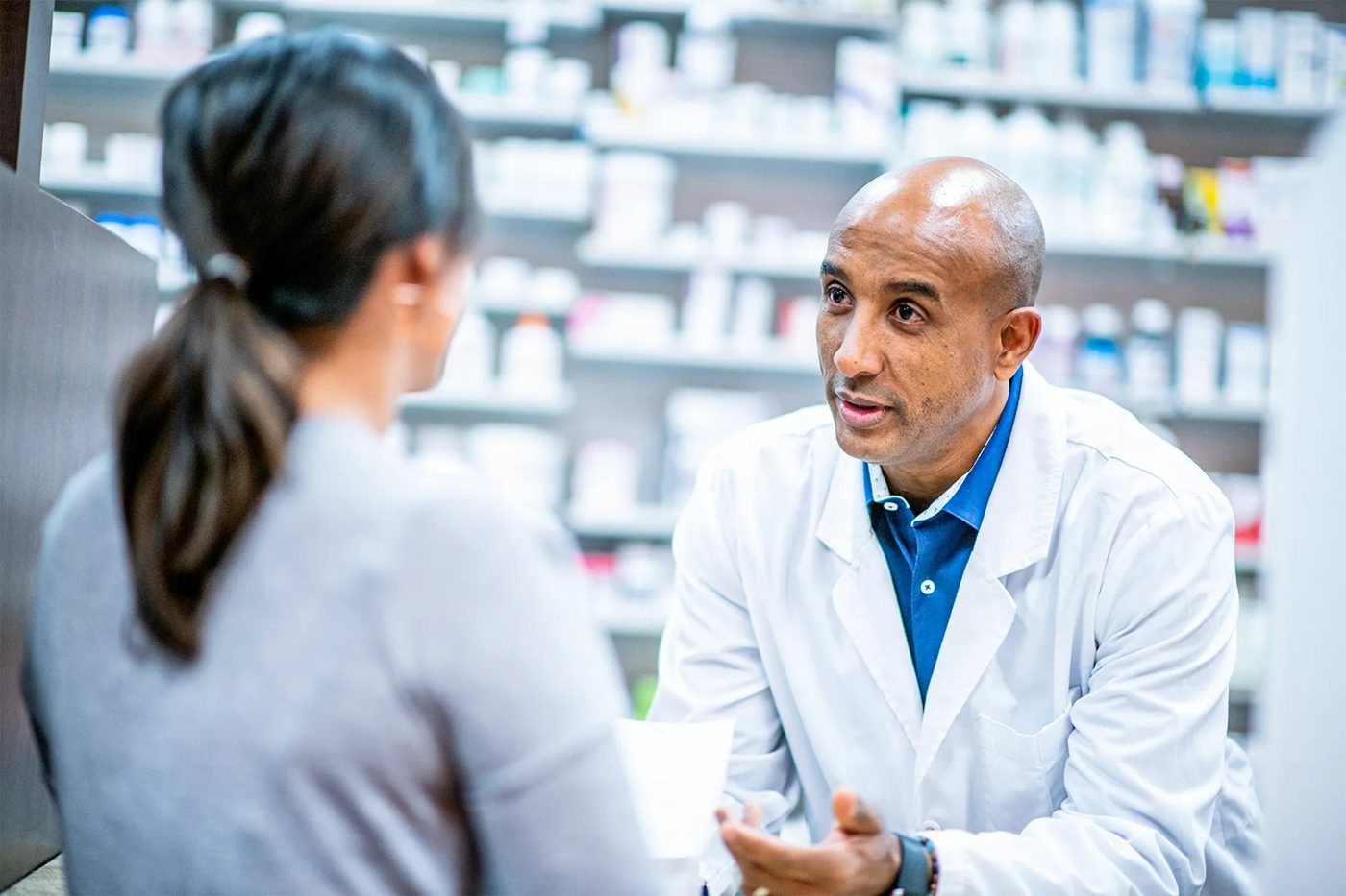 Pharmacist talking a patient through their treatment